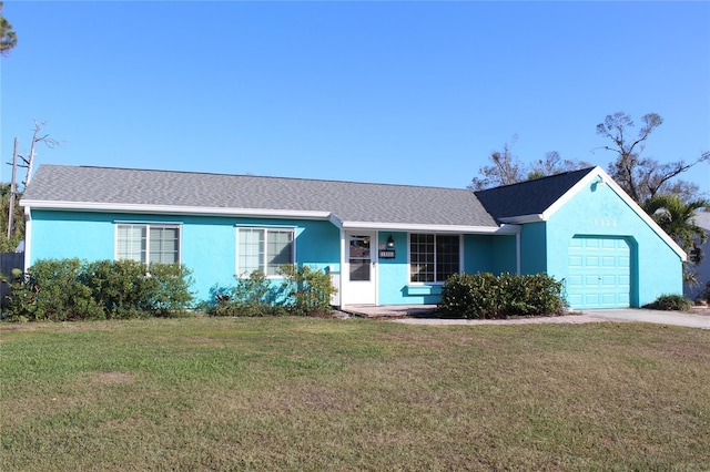 single story home featuring a garage and a front lawn