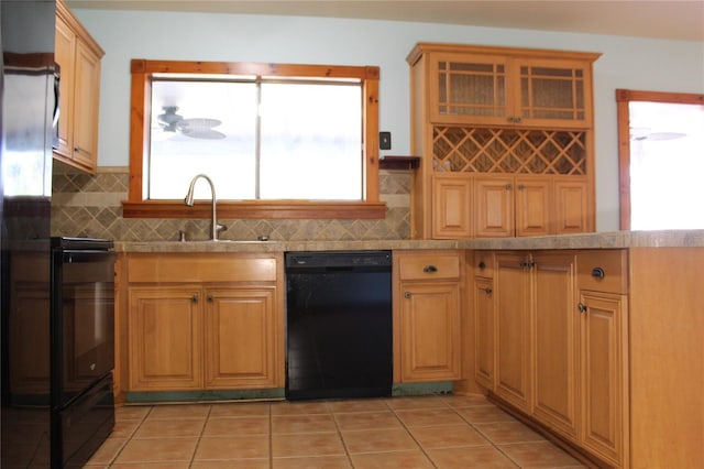 1322 Kenmore St, Port Charlotte, FL 33952 - kitchen with dishwasher, sink, a healthy amount of sunlight, and decorative backsplash