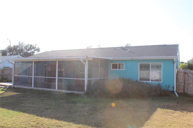 1322 Kenmore St, Port Charlotte, FL 33952 - back of property featuring a sunroom and a lawn