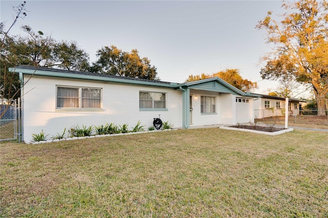 single story home featuring a front lawn