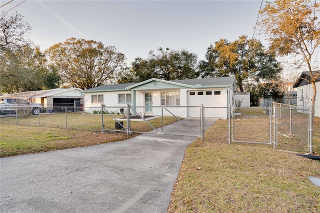 ranch-style house featuring a garage and a front yard