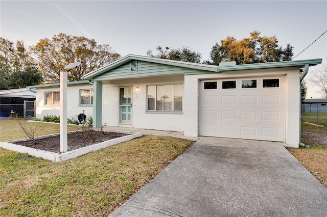 ranch-style home featuring a garage and a front lawn