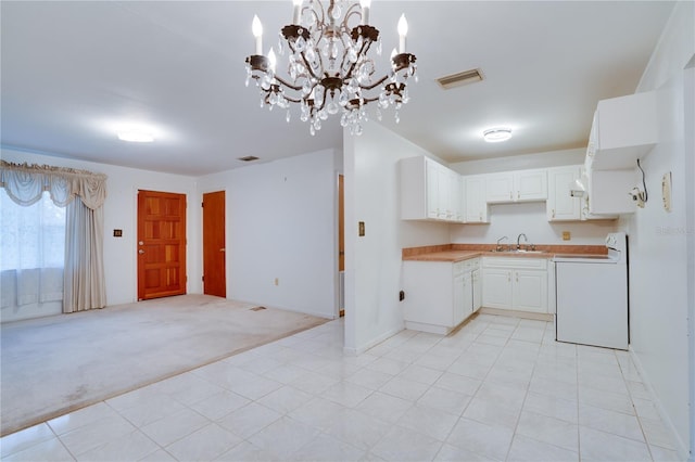 kitchen featuring pendant lighting, white cabinetry, sink, white electric range oven, and light colored carpet