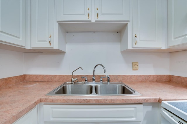 kitchen featuring white cabinetry and sink