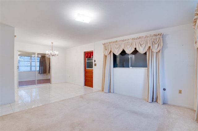 empty room featuring light carpet and an inviting chandelier