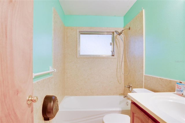 full bathroom with vanity, tiled shower / bath, and toilet