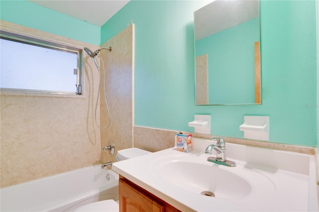 full bathroom with vanity, toilet, and tiled shower / bath combo