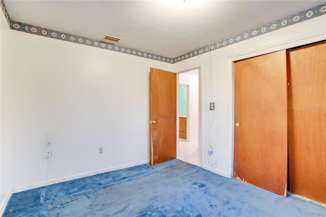 unfurnished bedroom with a closet and carpet flooring