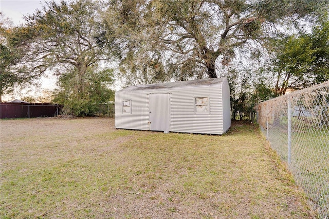 view of outbuilding featuring a yard