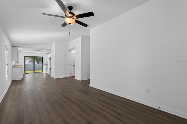 spare room with sink, dark wood-type flooring, ceiling fan, and vaulted ceiling