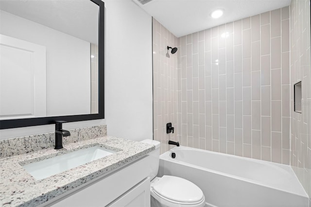 full bathroom with vanity, toilet, and tiled shower / bath