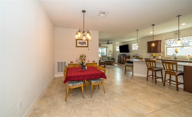 4748 Ballast Crest Cv, Land O Lakes, FL 34638 - dining space featuring a chandelier, ceiling fan, light tile patterned flooring, and baseboards