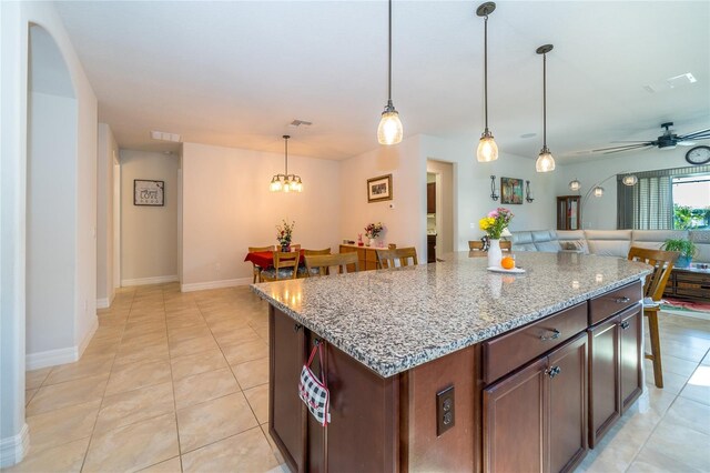 4748 Ballast Crest Cv, Land O Lakes, FL 34638 - kitchen with open floor plan, hanging light fixtures, a ceiling fan, and light tile patterned floors