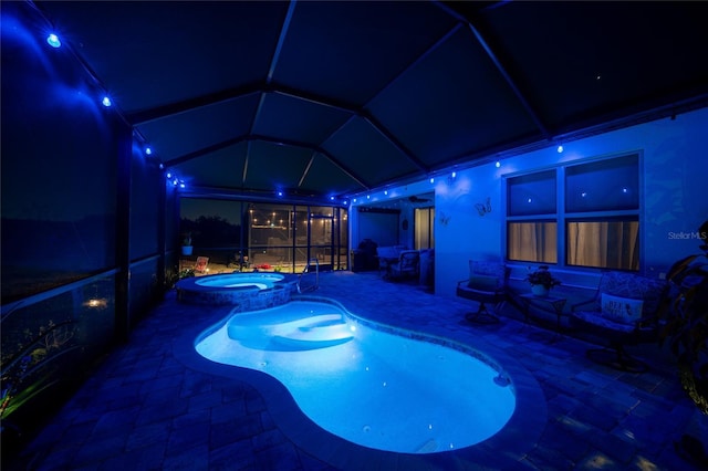 4748 Ballast Crest Cv, Land O Lakes, FL 34638 - pool at twilight with a patio area, a pool with connected hot tub, and glass enclosure