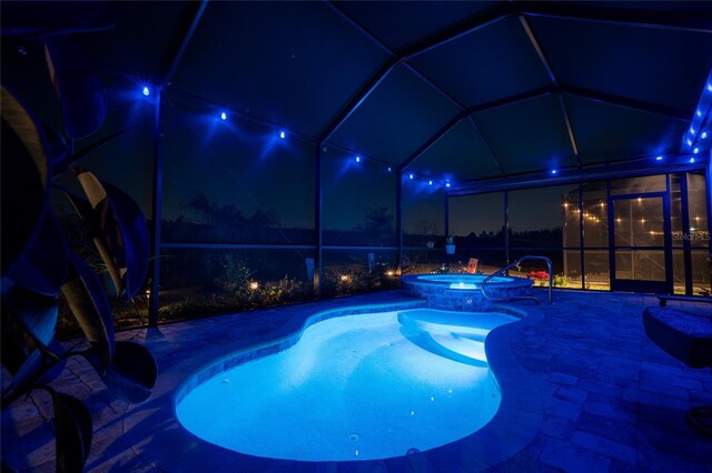 4748 Ballast Crest Cv, Land O Lakes, FL 34638 - pool at twilight with a lanai, a patio, and a pool with connected hot tub