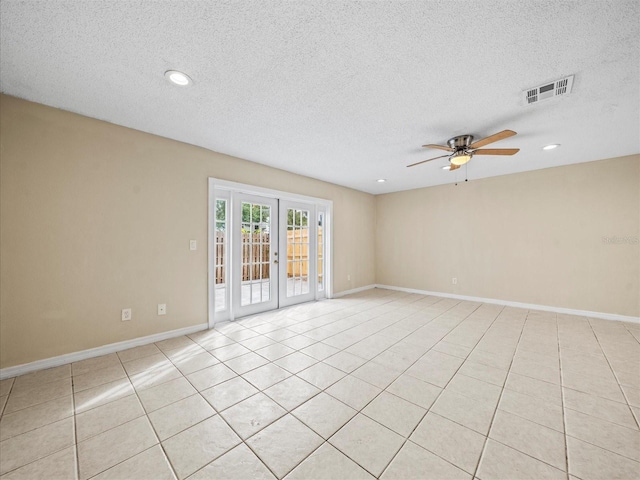 spare room with a textured ceiling, french doors, ceiling fan, and light tile patterned flooring