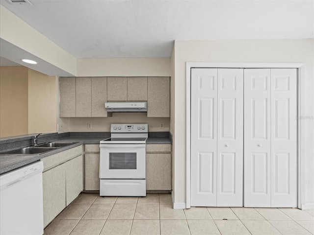 kitchen featuring sink, white appliances, and light tile patterned flooring