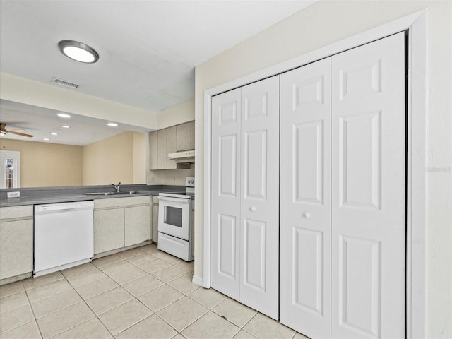 kitchen featuring ceiling fan, sink, light tile patterned floors, and white appliances