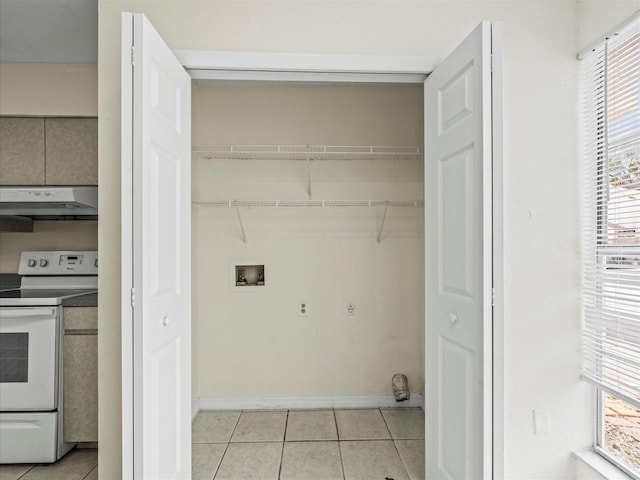 laundry area featuring washer hookup and light tile patterned flooring