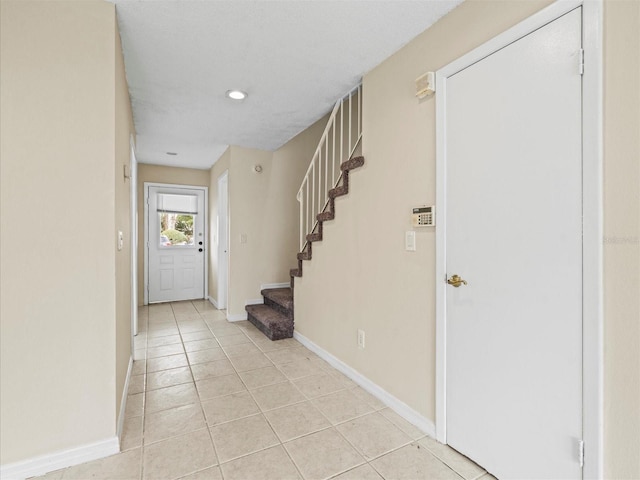 foyer featuring light tile patterned floors