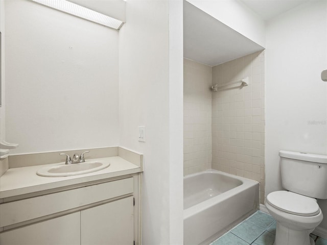 full bathroom with vanity, tiled shower / bath, tile patterned floors, and toilet