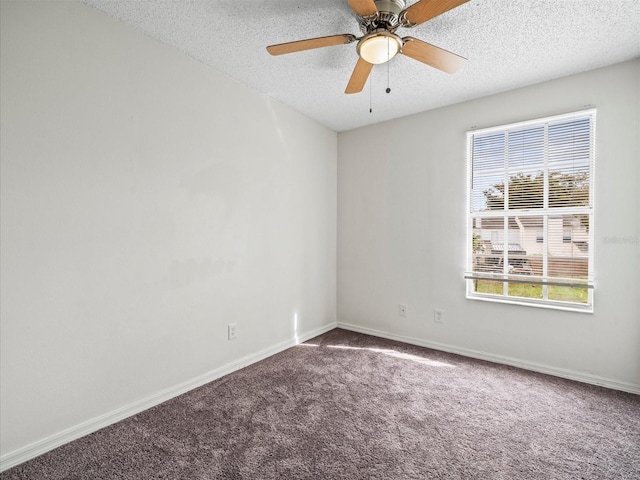 spare room featuring ceiling fan, carpet, and a textured ceiling