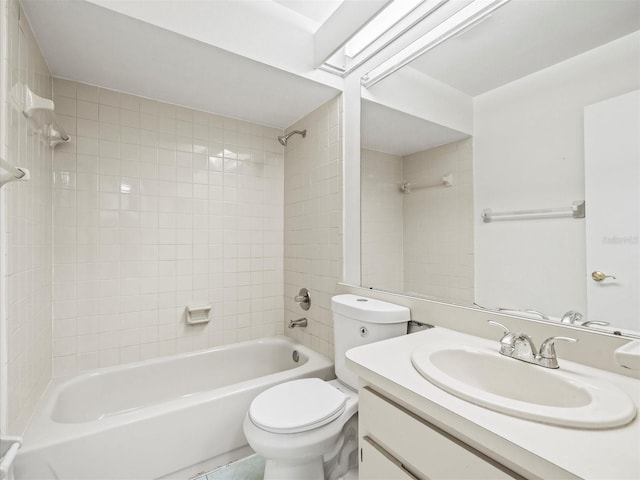 full bathroom with vanity, tiled shower / bath, and toilet