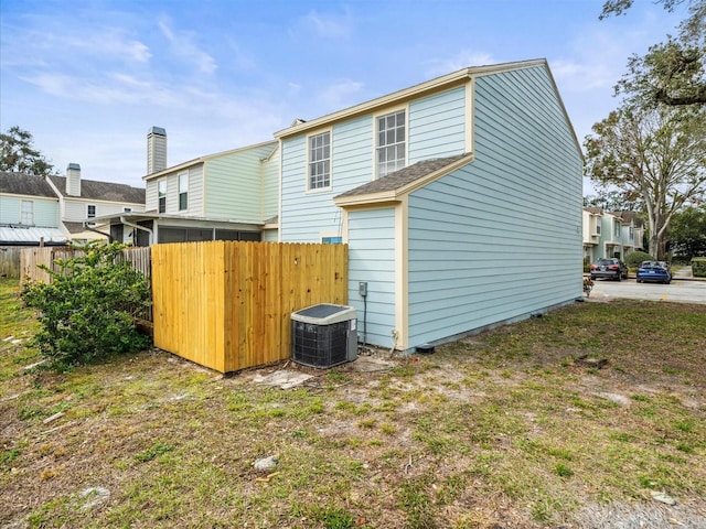 rear view of property featuring central AC