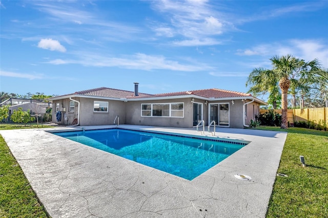 view of swimming pool with a lawn and a patio area