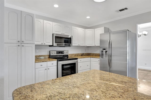 kitchen featuring white cabinetry, light stone countertops, ornamental molding, and appliances with stainless steel finishes