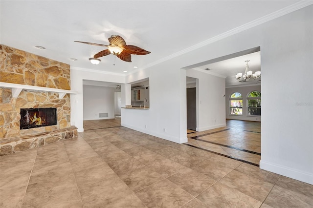 unfurnished living room with ceiling fan with notable chandelier, a fireplace, and ornamental molding