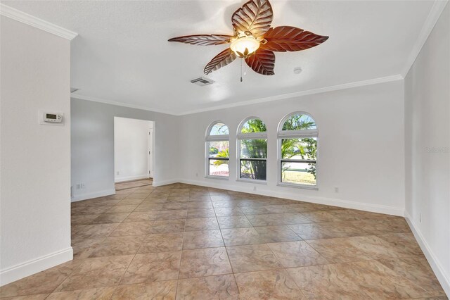 spare room featuring ornamental molding and ceiling fan