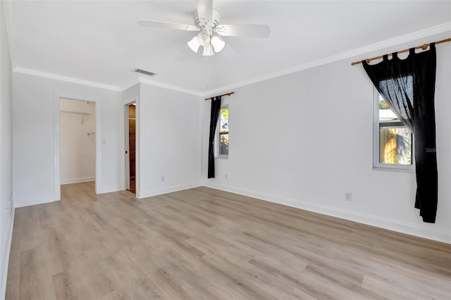 unfurnished room featuring ornamental molding, ceiling fan, and light wood-type flooring