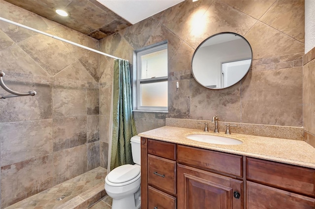 bathroom with vanity, curtained shower, tile walls, and toilet