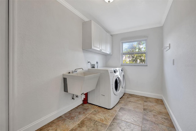 laundry room featuring crown molding, cabinets, separate washer and dryer, and sink