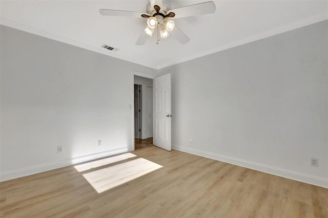 spare room featuring light hardwood / wood-style flooring, ornamental molding, and ceiling fan