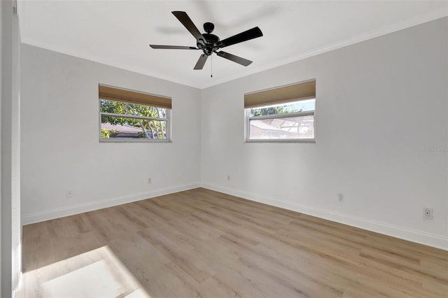 spare room featuring ornamental molding, light hardwood / wood-style floors, and ceiling fan