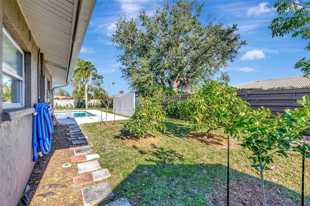 view of yard with a fenced in pool