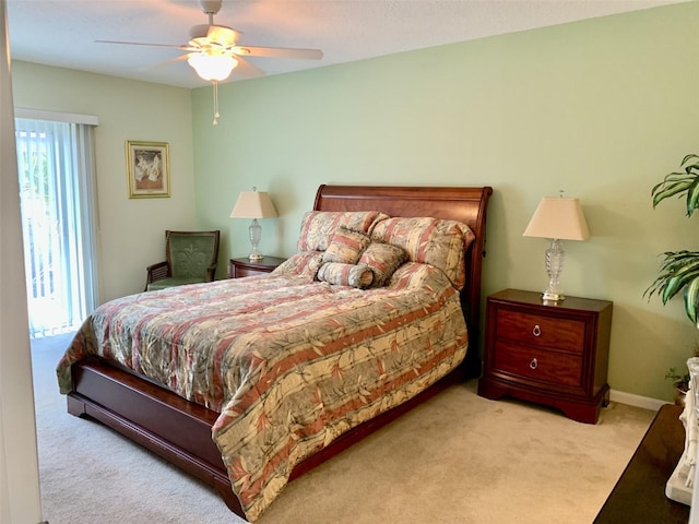 bedroom with baseboards, a ceiling fan, and light colored carpet