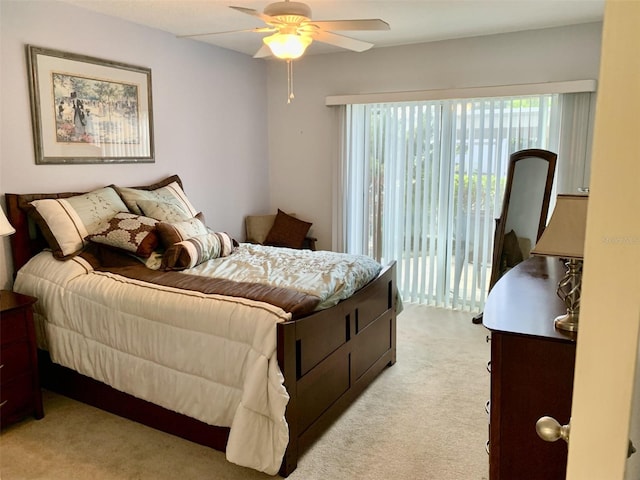 bedroom featuring light carpet, a ceiling fan, and access to exterior