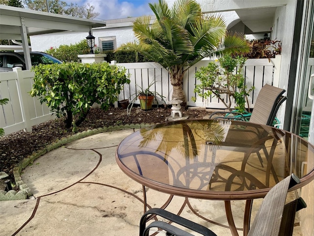 view of patio / terrace with outdoor dining space and fence