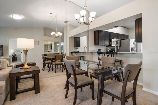 dining area with vaulted ceiling, sink, light colored carpet, and an inviting chandelier