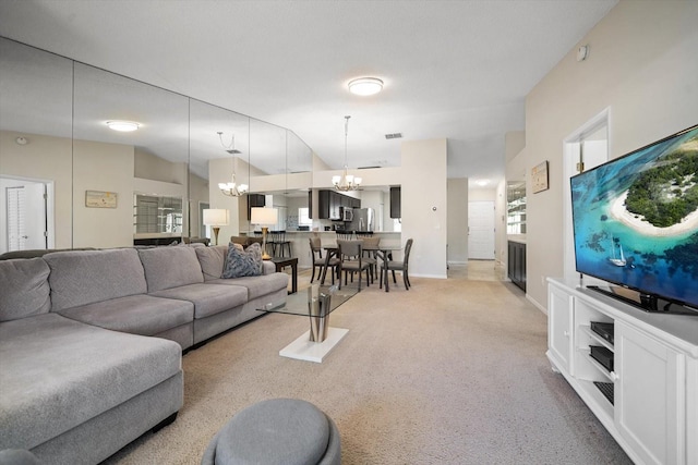 carpeted living room featuring a notable chandelier and vaulted ceiling