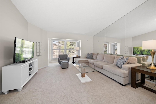 carpeted living room featuring high vaulted ceiling