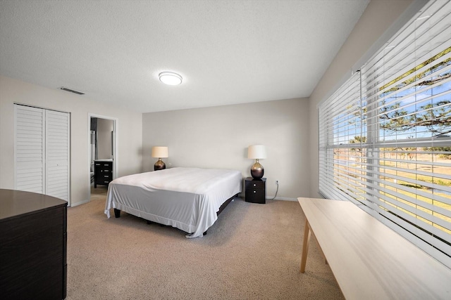 carpeted bedroom with a textured ceiling