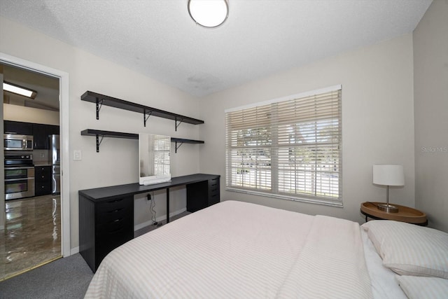 carpeted bedroom featuring stainless steel fridge and a textured ceiling