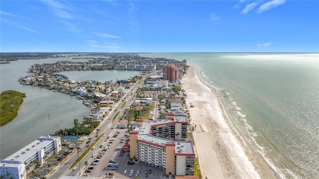 aerial view with a water view and a beach view