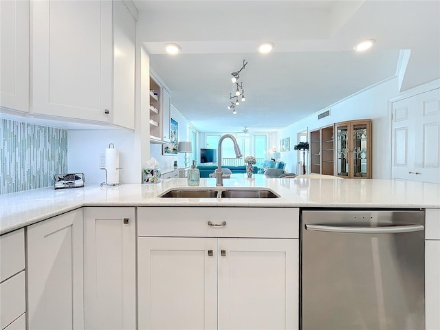 kitchen featuring tasteful backsplash, white cabinetry, dishwasher, sink, and kitchen peninsula