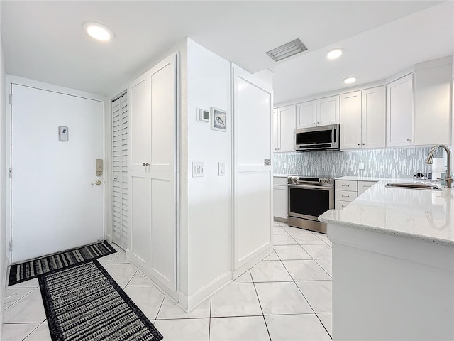 kitchen with white cabinetry, sink, and stainless steel appliances