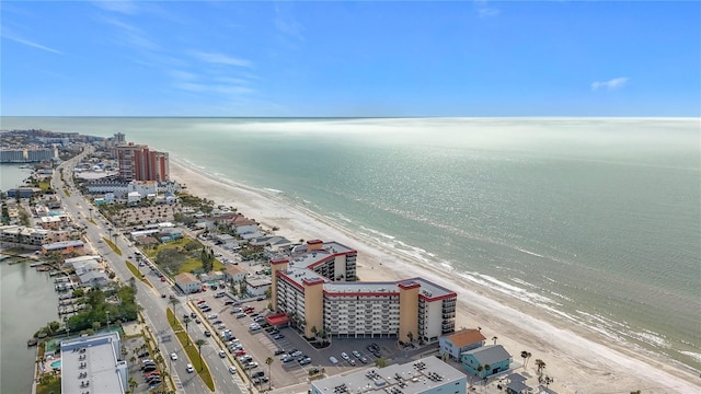 birds eye view of property with a water view and a view of the beach